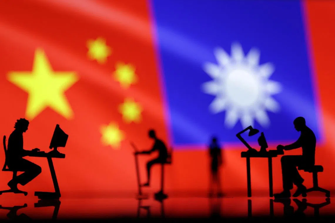 Small figurines with computers are seen in front of Chinese and Taiwanese flags in this illustration, August 6, 2022. REUTERS/Dado Ruvic/Illustration/ File Photo
