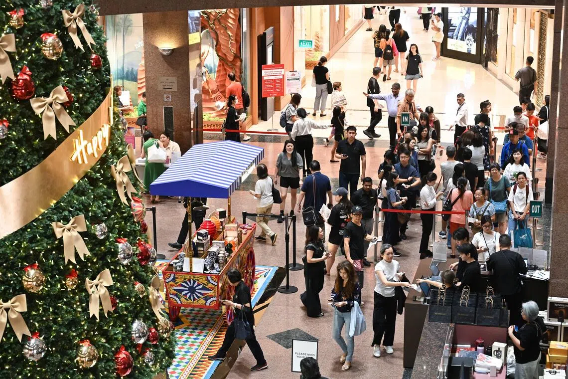 Shoppers at Takashimaya Department Store in Ngee Ann City on Nov 28 queueing for Black Friday promotions that include the Claw & Win lucky draw, with prizes such as iPhones and watches.
