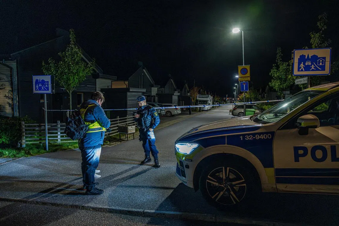 A police officer stands near police tape in Tullinge in Botkyrka, near Stockholm, Sweden, where a shooting took place, according to local media, October 13, 2023. Magnus Lejhall/TT News Agency/via REUTERS/File Photo