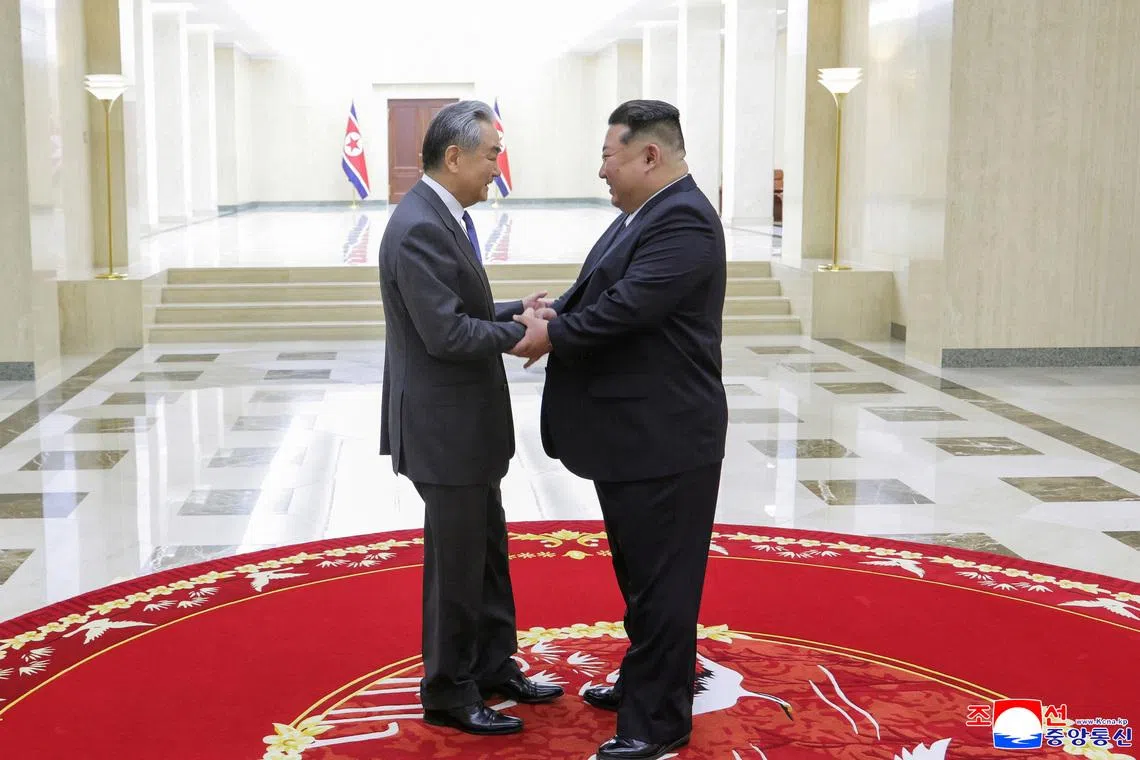 North Korean leader Kim Jong Un shakes hands with China's Foreign Minister Wang Yi as they meet in Pyongyang, North Korea, April 10, 2026, in this picture released by North Korea's official Korean Central News Agency.  KCNA via REUTERS