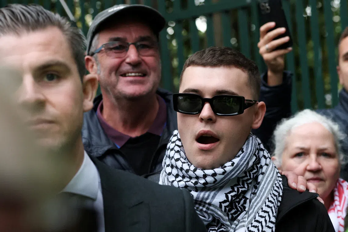 Member of Kneecap Liam O'Hanna, also known as Liam Og O hAnnaidh and performing under the name of Mo Chara, walks outside Woolwich Crown Court, after a UK court threw out his prosecution for a terrorism offence, in London, Britain, Friday September 26, 2025. REUTERS/Hannah McKay     TPX IMAGES OF THE DAY