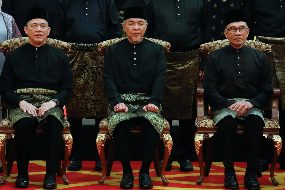 (From right) Malaysian PM Anwar Ibrahim and his deputies Zahid Hamidi and Fadillah Yusof after the Cabinet's swearing-in at the National Palace.