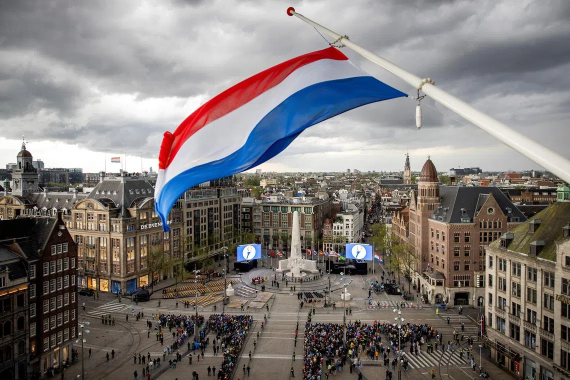 FILE PHOTO: People gather as The Netherlands holds its annual World War II remembrance ceremony in Amsterdam, Netherlands, May 4 2024. REMKO DE WAAL/Pool via REUTERS/File photo