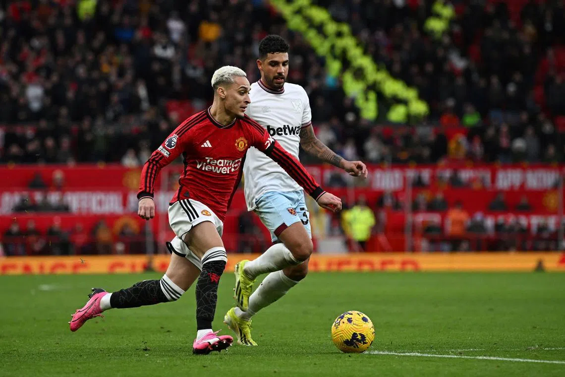Manchester United's Brazilian midfielder #21 Antony (L) fights for the ball with West Ham United's Italian defender #33 Emerson during the English Premier League football match between Manchester United and West Ham United at Old Trafford in Manchester, north west England, on February 4, 2024. (Photo by Paul ELLIS / AFP) / RESTRICTED TO EDITORIAL USE. No use with unauthorized audio, video, data, fixture lists, club/league logos or 'live' services. Online in-match use limited to 120 images. An additional 40 images may be used in extra time. No video emulation. Social media in-match use limited to 120 images. An additional 40 images may be used in extra time. No use in betting publications, games or single club/league/player publications. / 