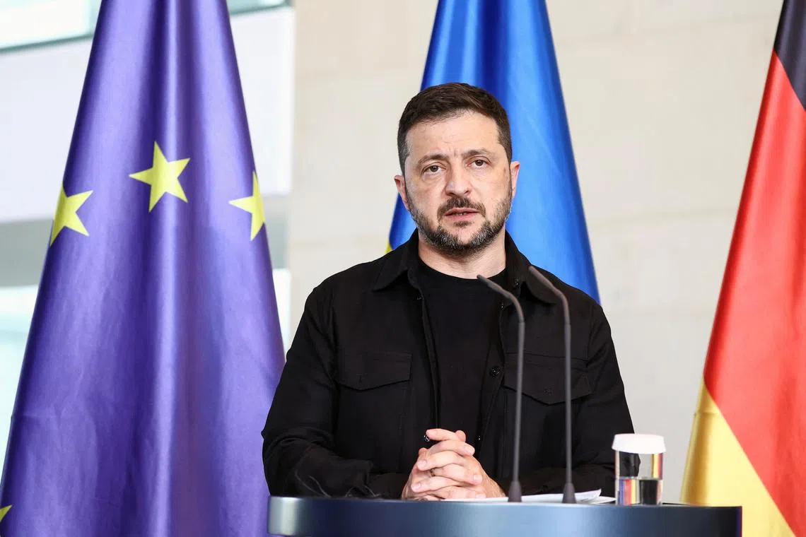 Ukrainian President Volodymyr Zelenskiy attends a press conference with German Chancellor Friedrich Merz (not pictured), on the day they attend a virtual meeting with U.S. President Donald Trump and European leaders on the upcoming Trump-Putin summit on Ukraine, in Berlin, Germany, August 13, 2025. REUTERS/Liesa Johannssen