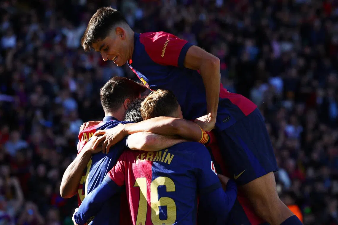 Soccer Football - LaLiga - FC Barcelona v Girona - Estadi Olimpic Lluis Companys, Barcelona, Spain - March 30, 2025 FC Barcelona's Robert Lewandowski celebrates with teammates after scoring their second goal REUTERS/Albert Gea