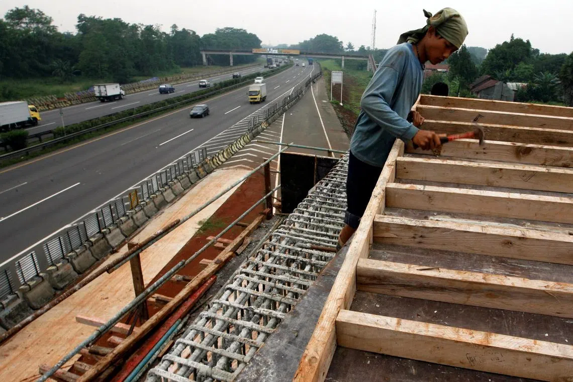 A worker constructs a new toll road by Indonesian toll road operator PT Jasa Marga on the outskirts of Jakarta. 