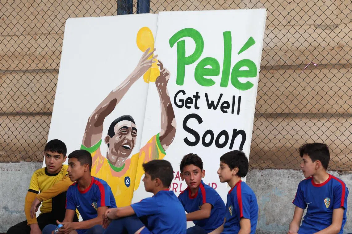 Displaced Syrian children paying tribute to Brazilian football legend Pele before a match in Syria on Dec 9, 2022. 