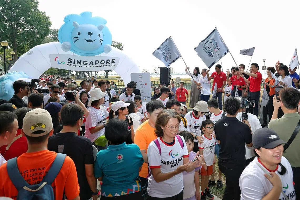 Prime Minister Lawrence Wong flagging off the 3km Paralympic Walkathon at the launch of the inaugural Paralympic Day at Angsana Green, East Coast Park, on Aug 29, 2026. Flagging off the walkathon alongside PM Wong are (on stage, from left) MPs for East Coast GRC Hazlina Abdul Halim, Edwin Tong, Dinesh Vasu Dash, SNPC president Teo-Koh Sock Miang, South West District mayor Low Yen Ling, and MP for East Coast GRC Jessica Tan.