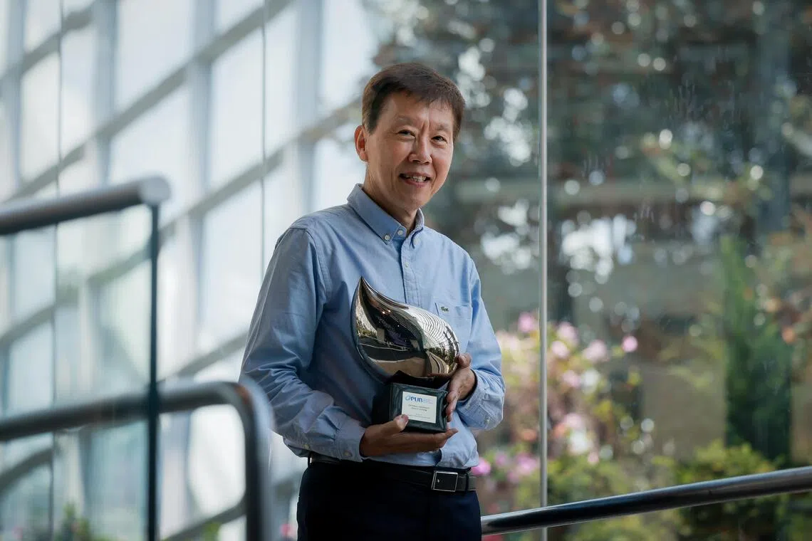 NUHS Chief Operating Officer Ng Kian Swan poses with his Singapore Watermark Award at the award ceremony.