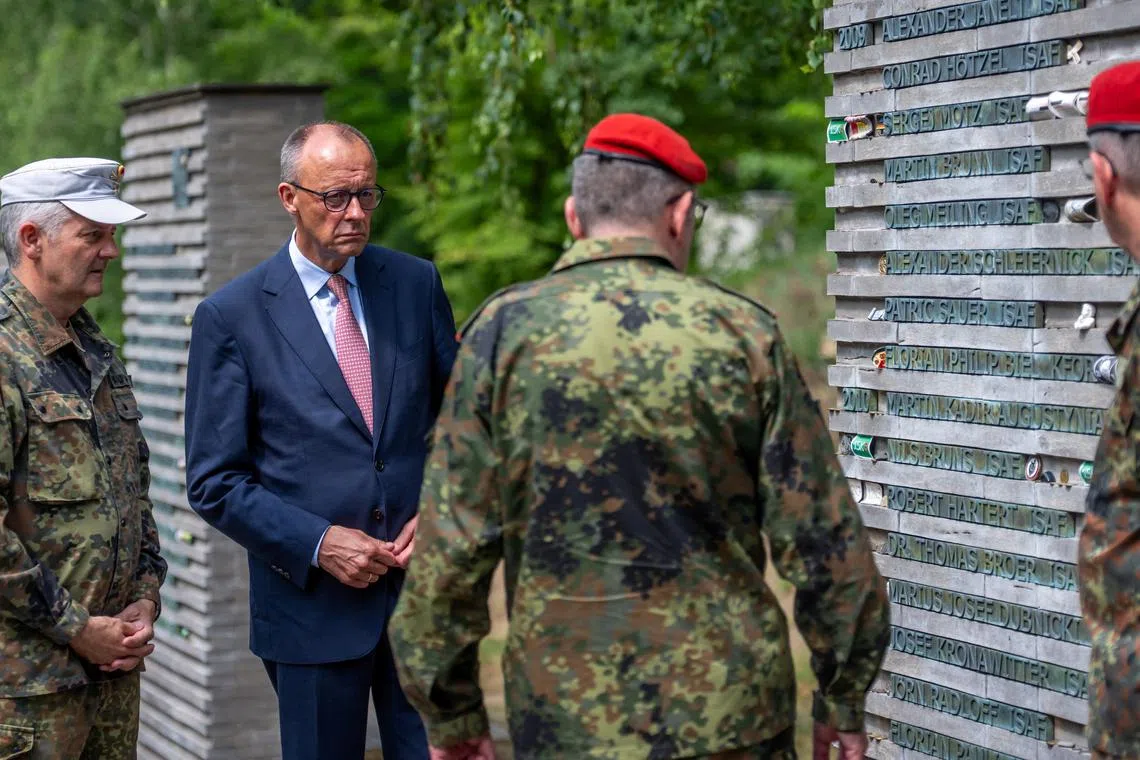 German Chancellor Friedrich Merz talks to soldiers in the so-called \"Forest of Remembrance\" following his visit to the Operational Command of the German armed forces Bundeswehr in Schwielowsee near Berlin, Germany, June 28, 2025.     Michael Kappeler/Pool via REUTERS/File Photo