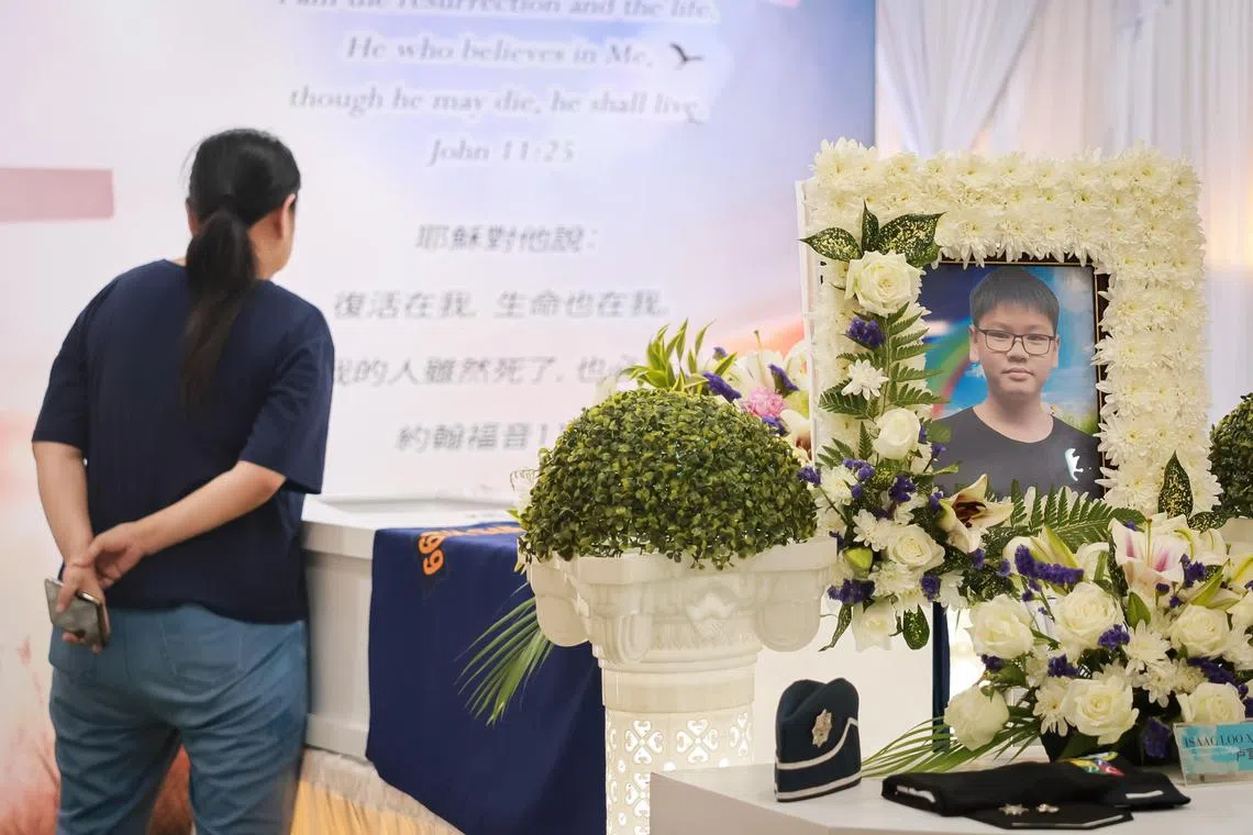 Madam Fiona Soo (dark blue top), 51, at the wake of her youngest son, Issac Loo, 9, held at a pavilion at Woodlands Circle on May 28, 2024.