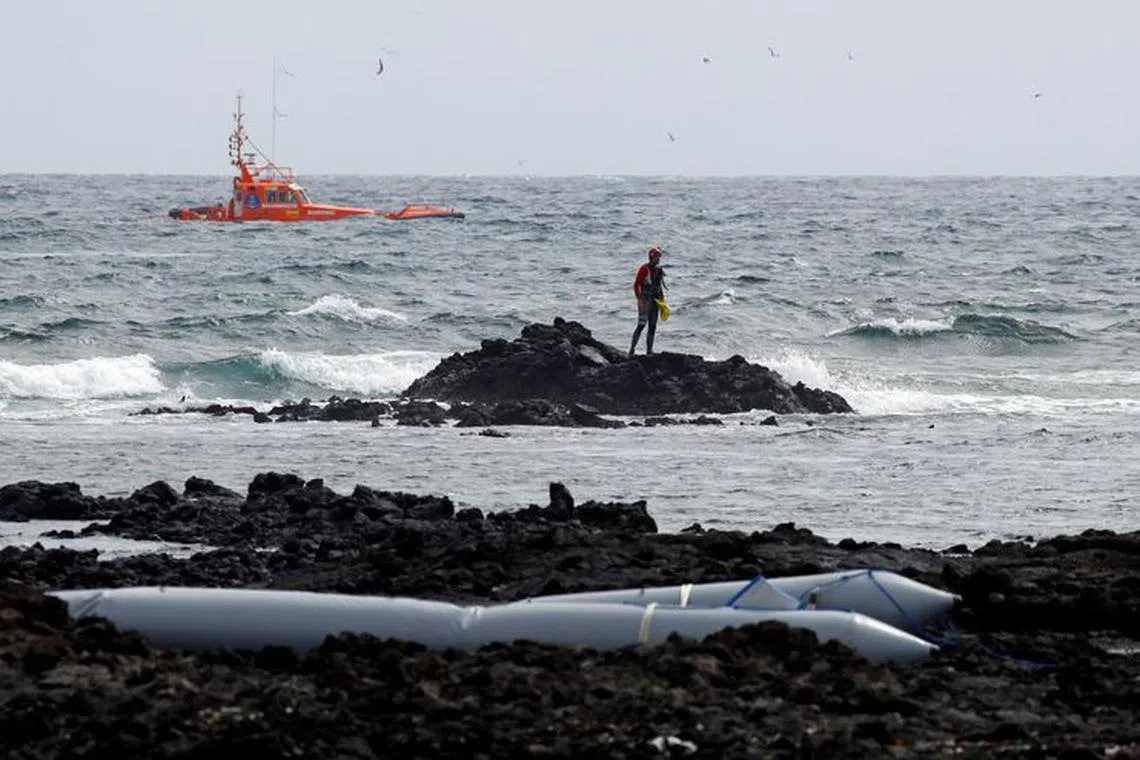FILE PHOTO: Rescue workers search for bodies after a boat with 46 migrants from the Maghreb region capsized in the beach of Orzola, in the Canary Island of Lanzarote, Spain June 18, 2021. REUTERS/Borja Suarez/File Photo