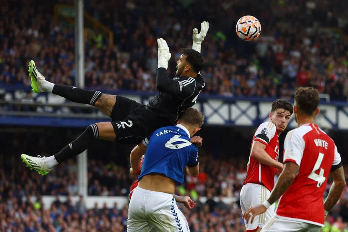 Soccer Football - Premier League - Everton v Arsenal - Goodison Park, Liverpool, Britain - September 17, 2023 Arsenal's David Raya in action with Everton's James Tarkowski Action Images via Reuters/Lee Smith