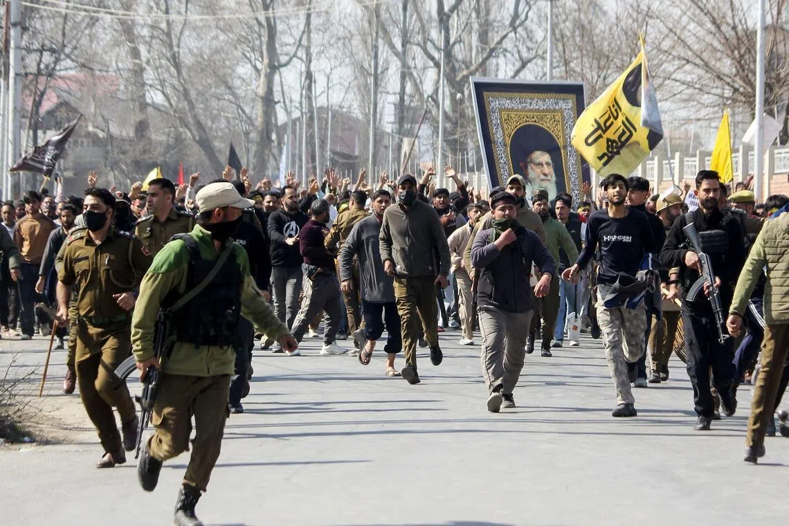 Protesters hold a portrait of Iran's late supreme leader Ayatollah Ali Khamenei in Srinagar on March 2, 2026.