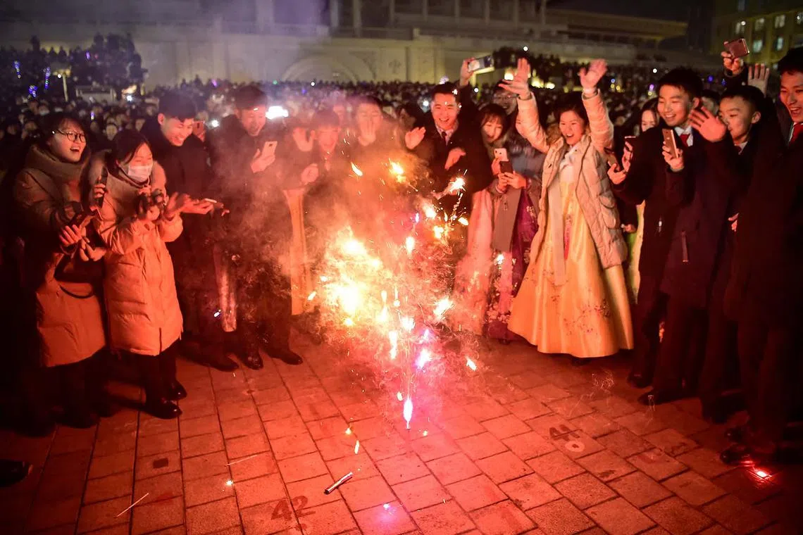 People taking part in celebrations to welcome in the new year at Kim Il Sung Square in Pyongyang on Jan 1, 2024. 