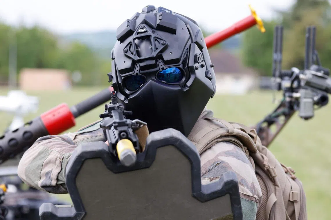 A French Army soldier wearing a "Ronin" testing helmet trains with an HK416 assault rifle, during the CoHoMa challenge in Beynes, west of Paris, on May 7.