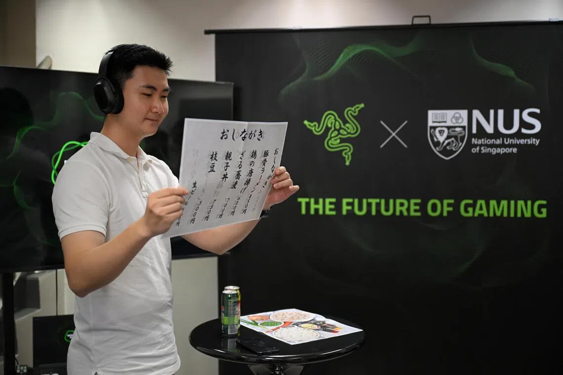 A Razer employee demonstrates how Project Motoko can translate a Japanese menu to English, at the launch of the Razer-NUS Joint AI Research Lab on Aug 5.