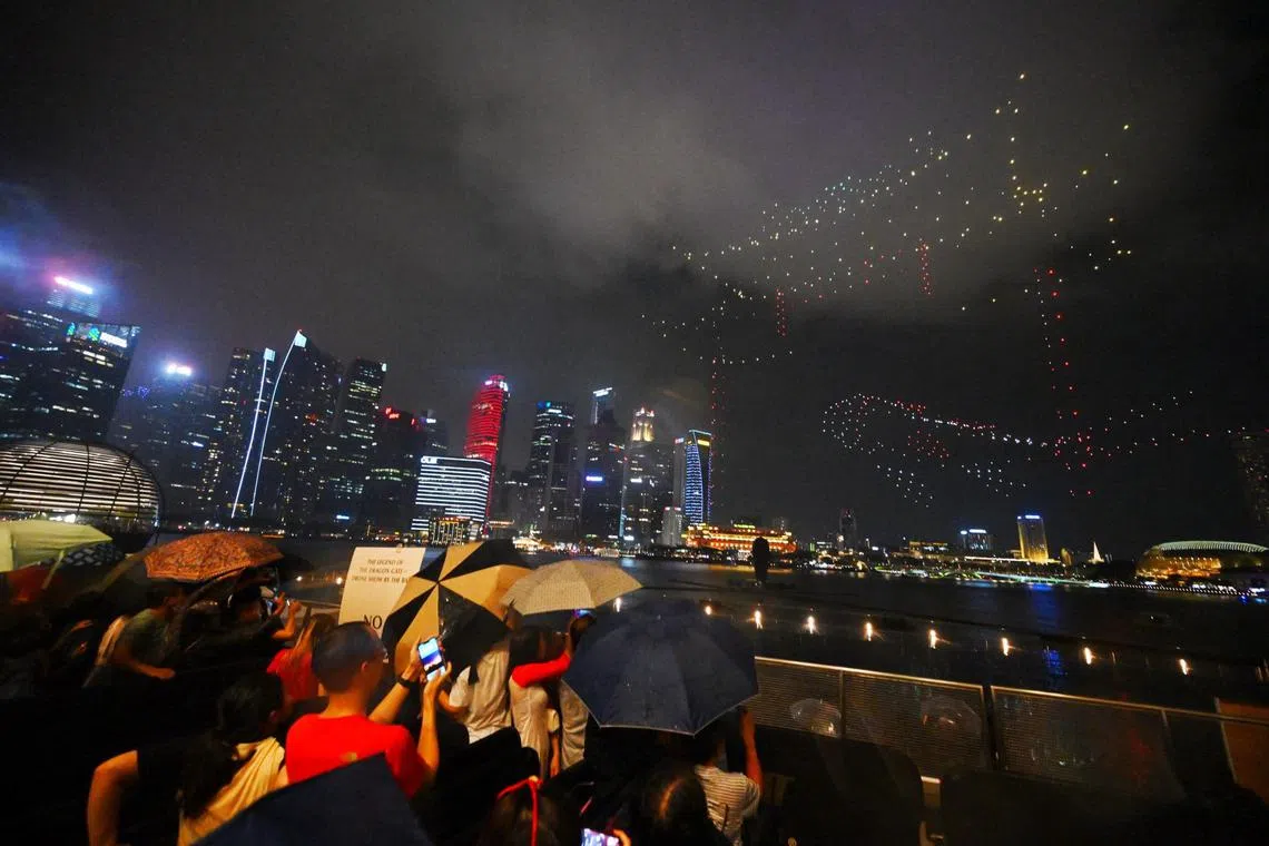 Even though it rained shortly after the start of the drone show at 8pm on Feb 10, many visitors had gathered to witness it.