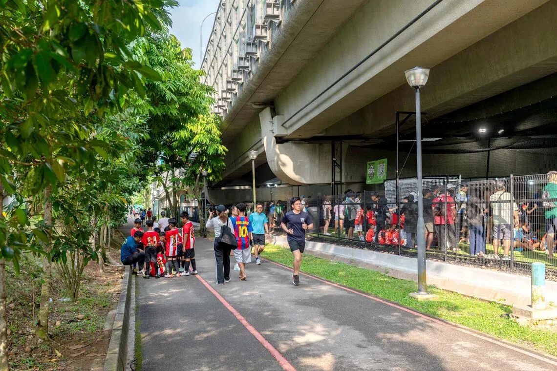 ARK Sports Village, which has pickleball and futsal courts under the viaduct, abuts a park connector frequeted by cyclists and walkers.