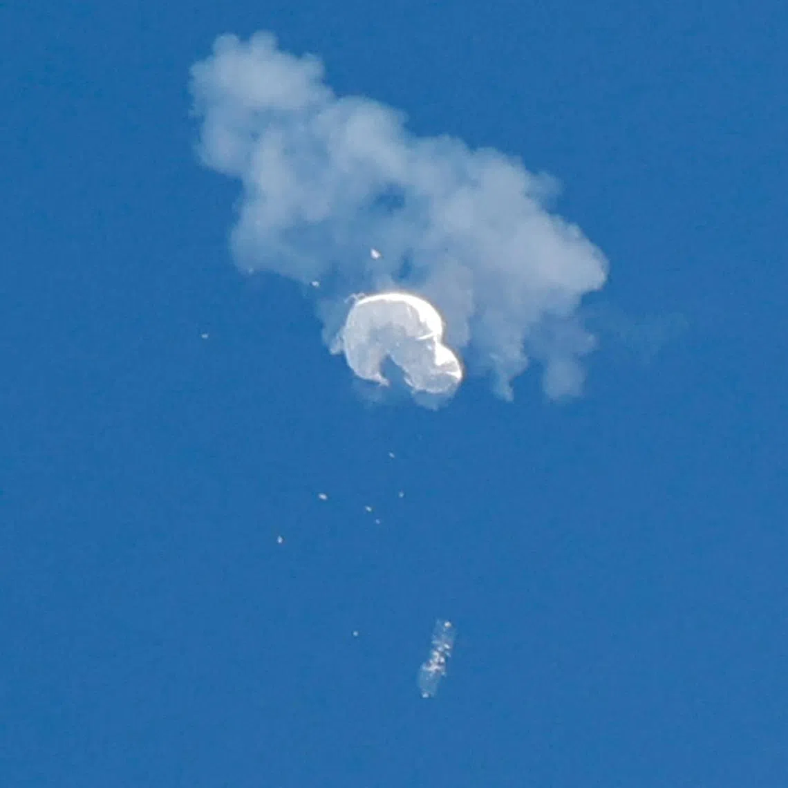 The suspected Chinese spy balloon drifts to the ocean after being shot down off the coast in Surfside Beach, South Carolina, U.S. February 4, 2023.