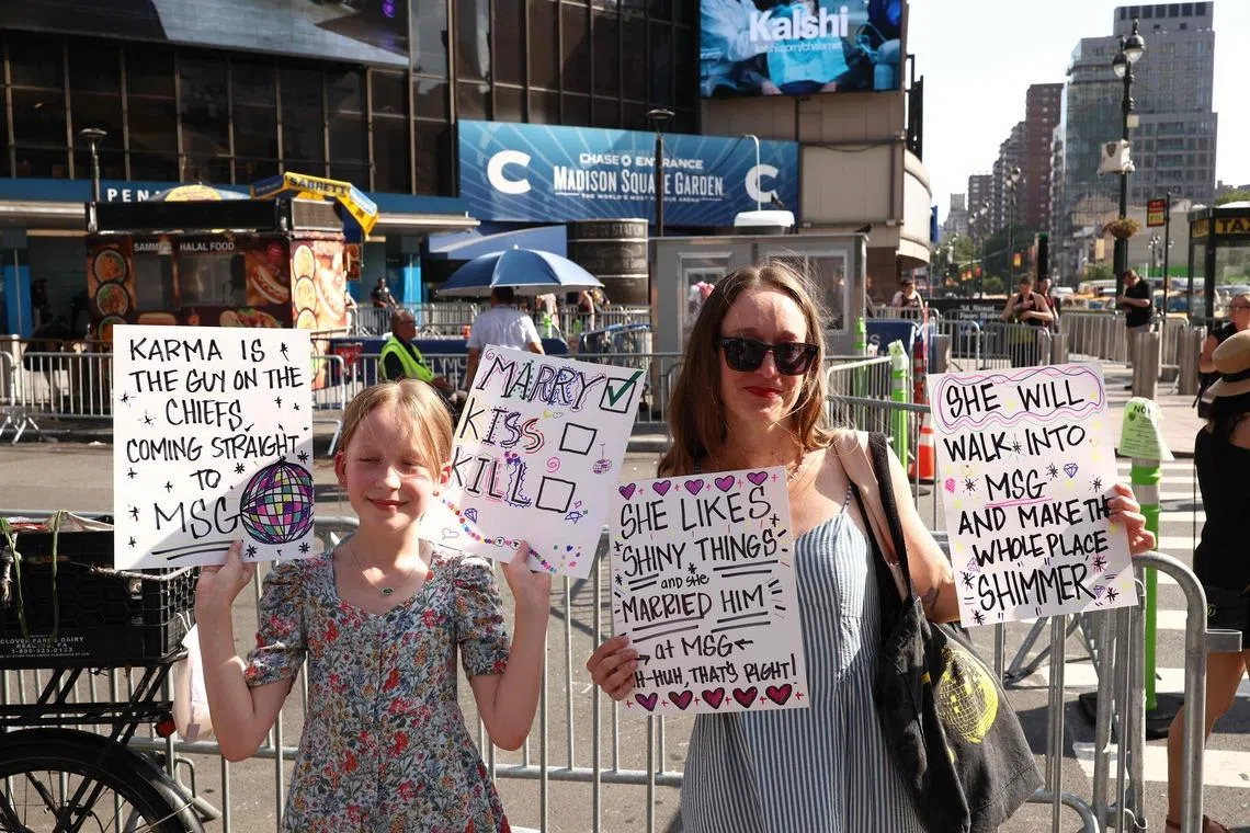 Taylor Swift fans hold signs outside Madison Square Garden on July 3.