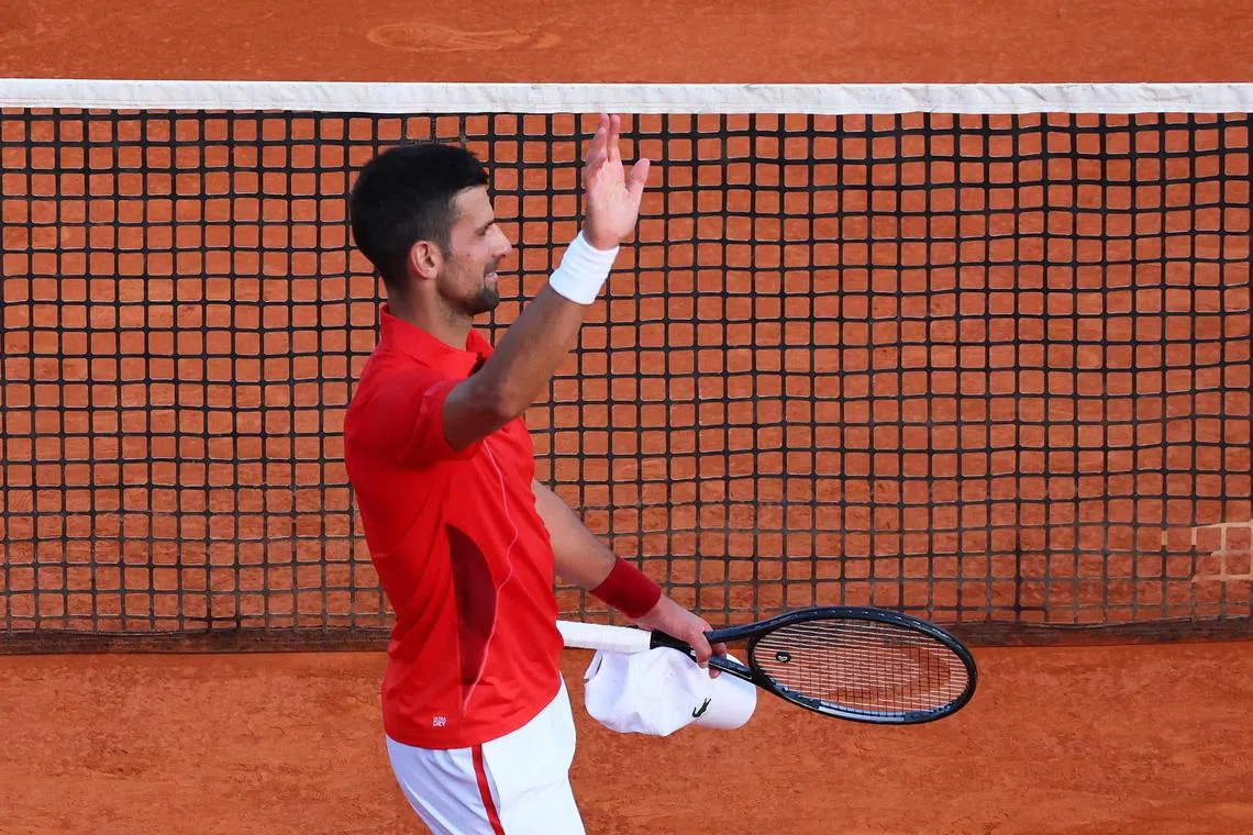 Serbia's Novak Djokovic celebrates after winning his quarter-final match against Australia's Alex de Minaur.