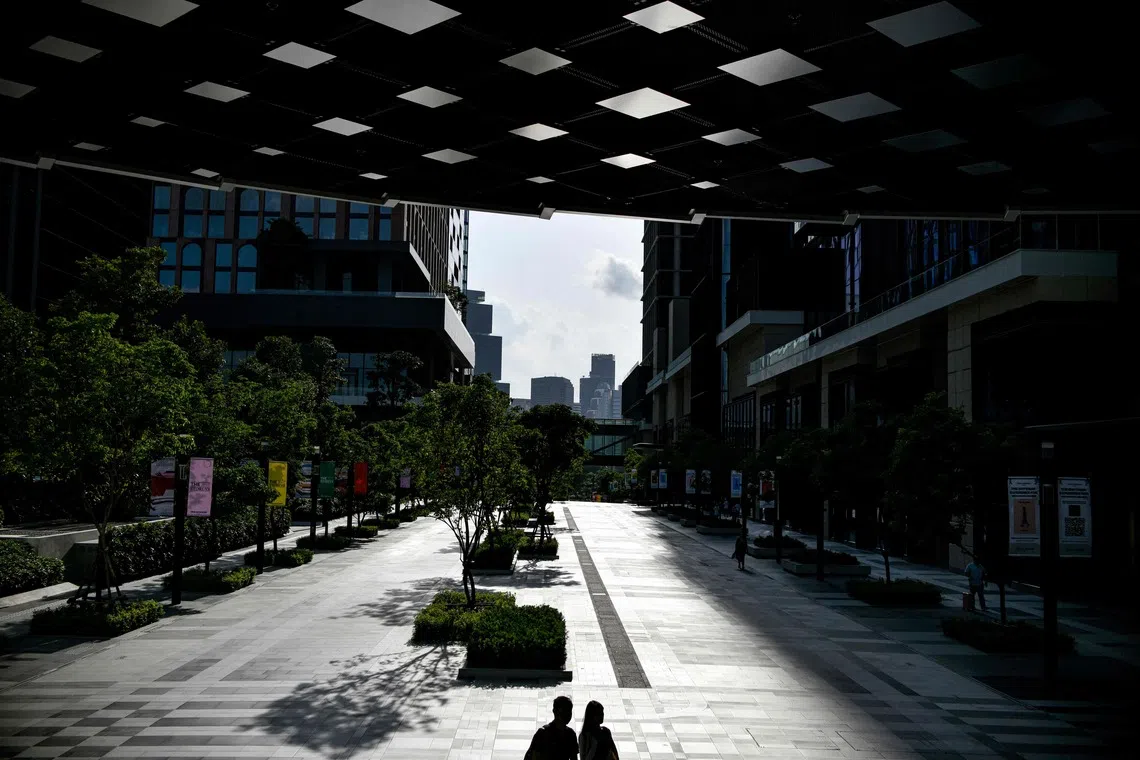 People walk at One Bangkok mall in Bangkok on July 31.