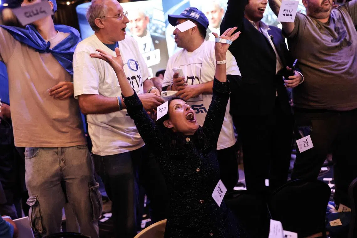 Supporters of Likud party leader and Israel’s Prime Minister Benjamin Netanyahu celebrate early on Oct 28.