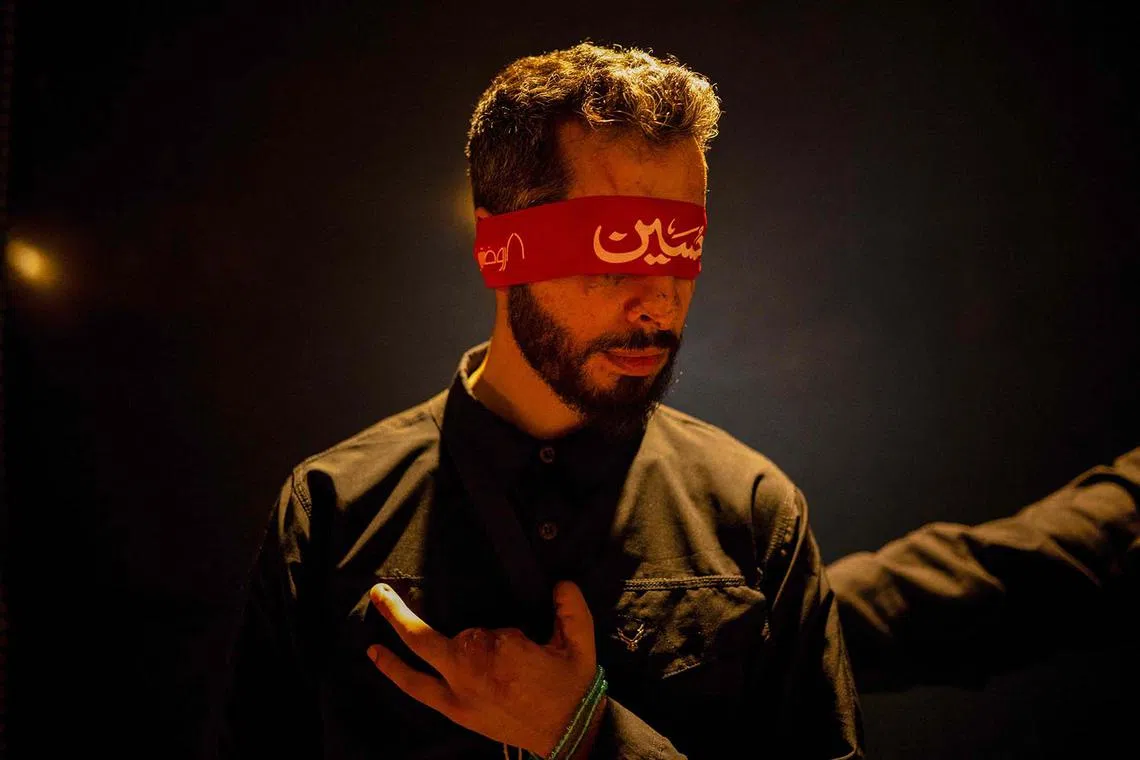 Hasan Zwaweh, a 30-year-old man who lost his sight and part of his hand in the Israeli operation that detonated hundreds of pagers and walkie-talkies used by Hezbollah, attending a mourning ritual in Iraq's central holy shrine city of Karbala on Aug 13, 2025, on the eve of the Arbaeen commemorations that marks the end of the 40-day mourning period for the seventh century killing of the Prophet Mohamed's grandson Imam Hussein ibn Ali. 