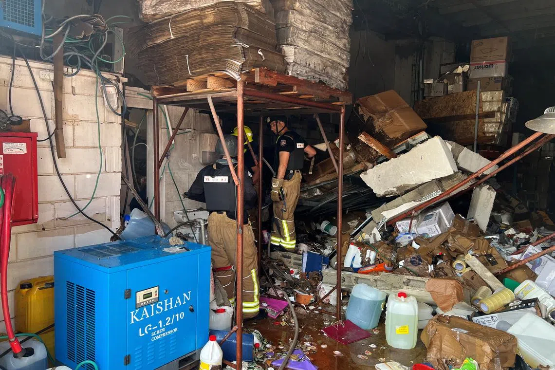 Firefighters work at the site where a rocket landed after a lethal rocket strike on Israel, amid ongoing cross-border hostilities between Hezbollah and Israeli forces, at a factory in Kiryat Shmona, northern Israel March 27, 2024. REUTERS/Avi Ohayon
