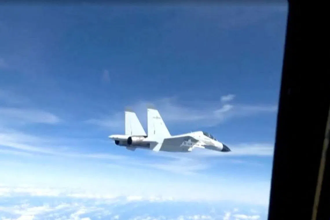 A Chinese military plane came within 20 feet (6 meters) of a U.S. Air Force aircraft, in this still image taken from a video, December 21, 2022. U.S. Department of Defense /Handout via REUTERS/File Photo
