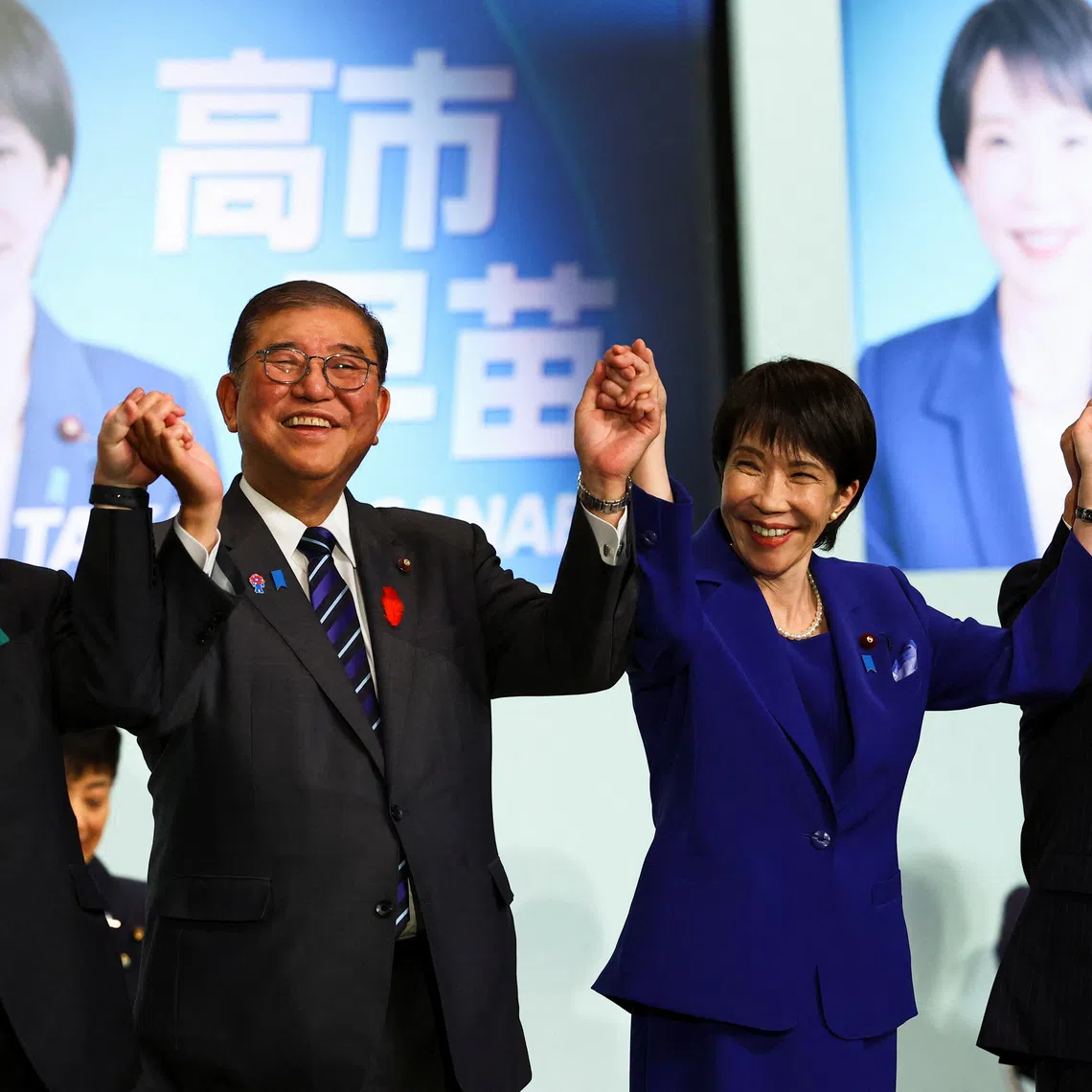 Newly-elected leader of Japan's Liberal Democratic Party (LDP) Sanae Takaichi celebrates with Prime Minister Shigeru Ishiba and other leadership candidates, Japan's Chief Cabinet Secretary Yoshimasa Hayashi and former Foreign Minister Toshimitsu Motegi, after winning the LDP leadership election in Tokyo, Japan, October 4, 2025. REUTERS/Kim Kyung-Hoon/Pool