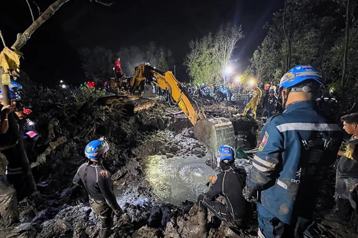 Rescue workers conducting a search and rescue operating to recover the wreckage of a plane after it crashed into a mangrove forest in Chachoengsao province.