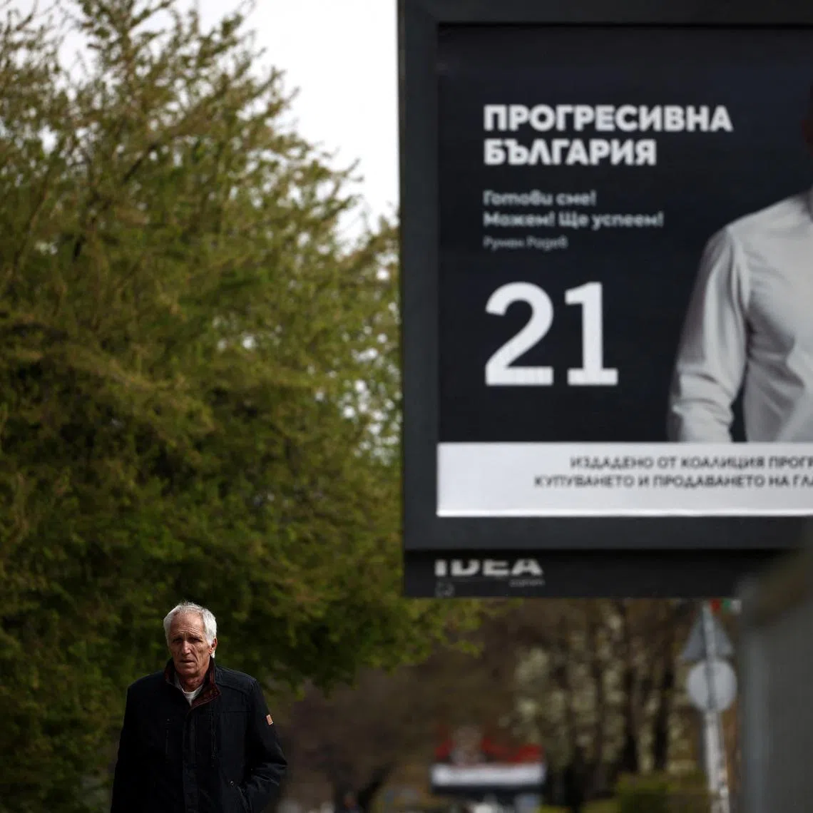 A man walks past an election billboard of the Progressive Bulgaria coalition's leader and former President Rumen Radev, ahead of the snap election, in Sofia, Bulgaria, April 14, 2026. REUTERS/Spasiyana Sergieva