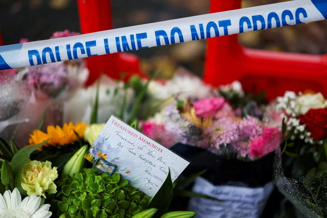 A note is left with floral tributes near the Manchester synagogue, where multiple people were killed on Yom Kippur, in what police have declared a terrorist incident, in north Manchester, Britain, October 4, 2025. REUTERS/Hannah McKay