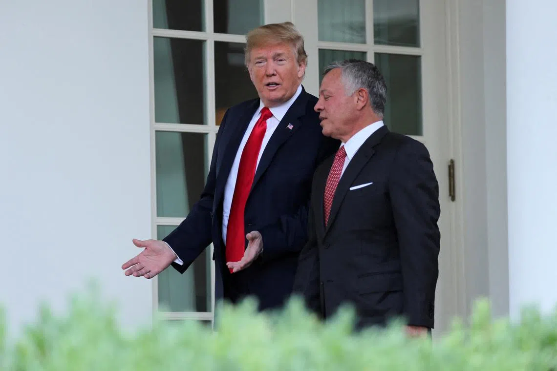 FILE PHOTO: U.S. President Donald Trump walks down the West Wing colonnade with Jordan’s King Abdullah as he welcomes the King to the White House in Washington, U.S., June 25, 2018. REUTERS/Jonathan Ernst/File Photo