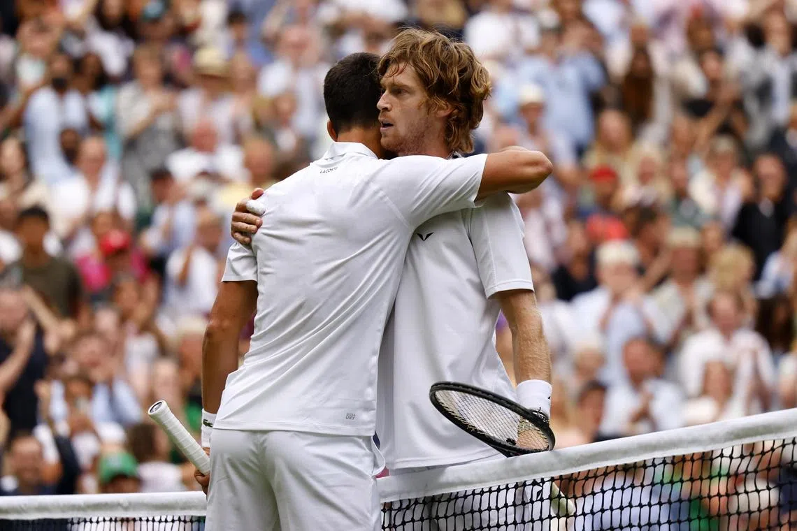 Russia's Andrey Rublev congratulates Novak Djokovic after their quarter-final match.