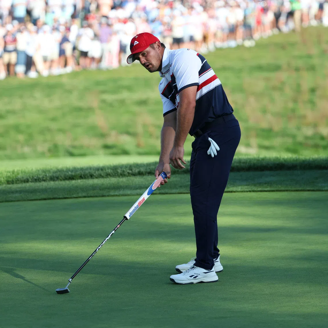 Golf - The 2025 Ryder Cup - Bethpage Black Golf Course, Farmingdale, New York, United States - September 28, 2025 Team USA's Bryson DeChambeau reacts to a missed putt on the 17th hole during the singles REUTERS/Brendan Mcdermid