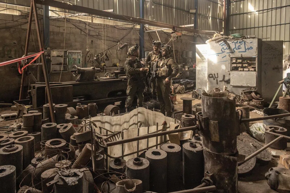 Israeli soldiers stand in what they described as a rocket factory in the central Gaza Strip on Jan. 8, 2024. 