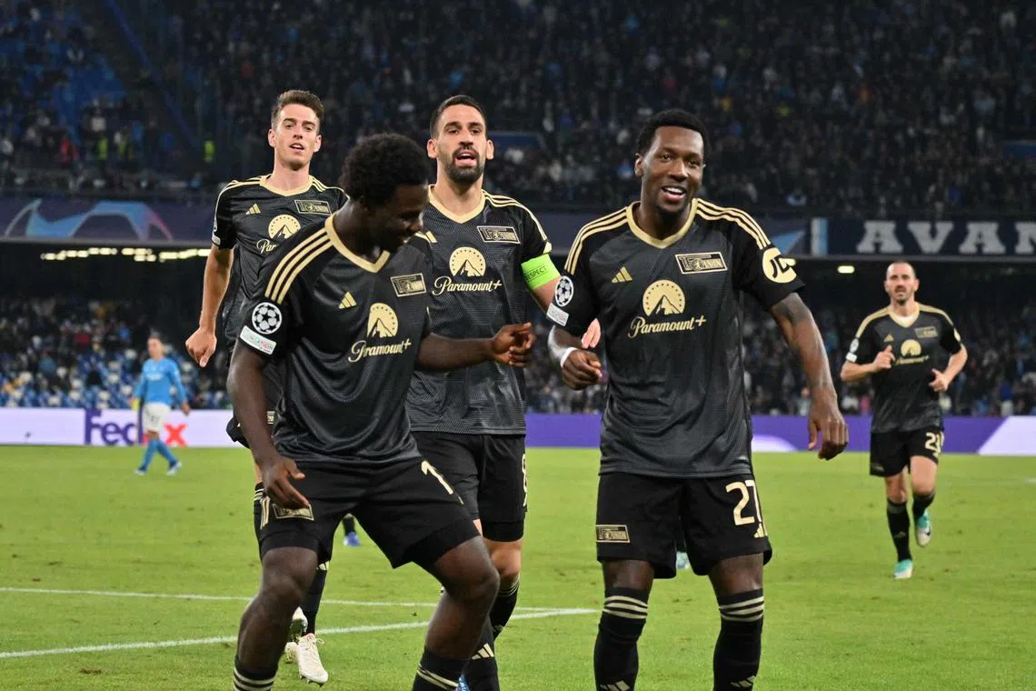 Union Berlin's David Fofana celebrates with his teammates after scoring the equaliser.