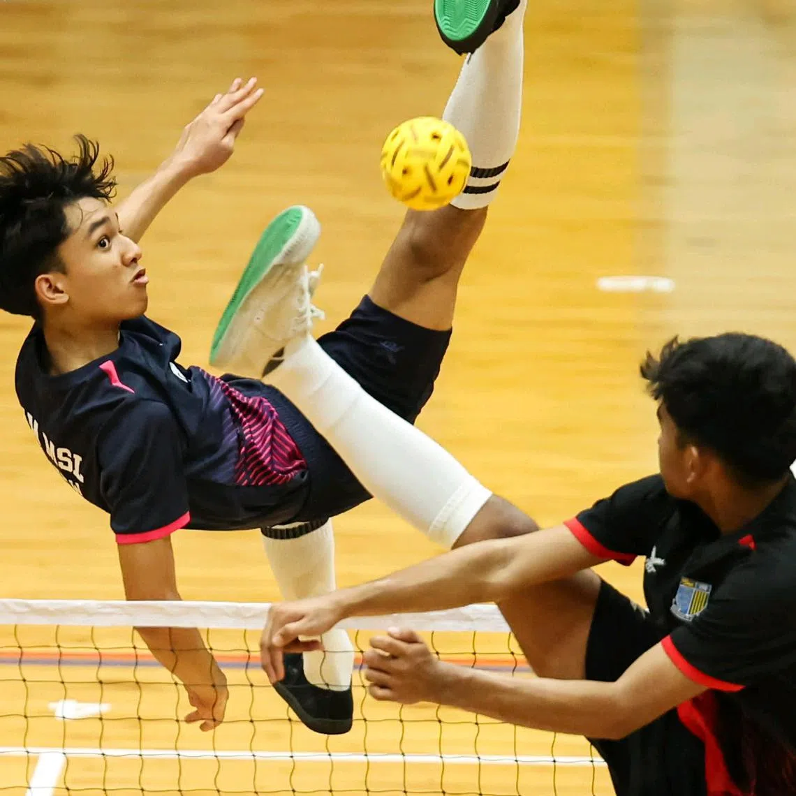 Muhammad Herzy Khaliff Muhammad Firdaus (left), Marsiling Secondary School student, in action against Naval Base Secondary School students in the National School Games 2025 B Division Sepak Takraw Finals at Yio Chu Kang Sports Hall on March 10, 2025. ST PHOTO: BRIAN TEO