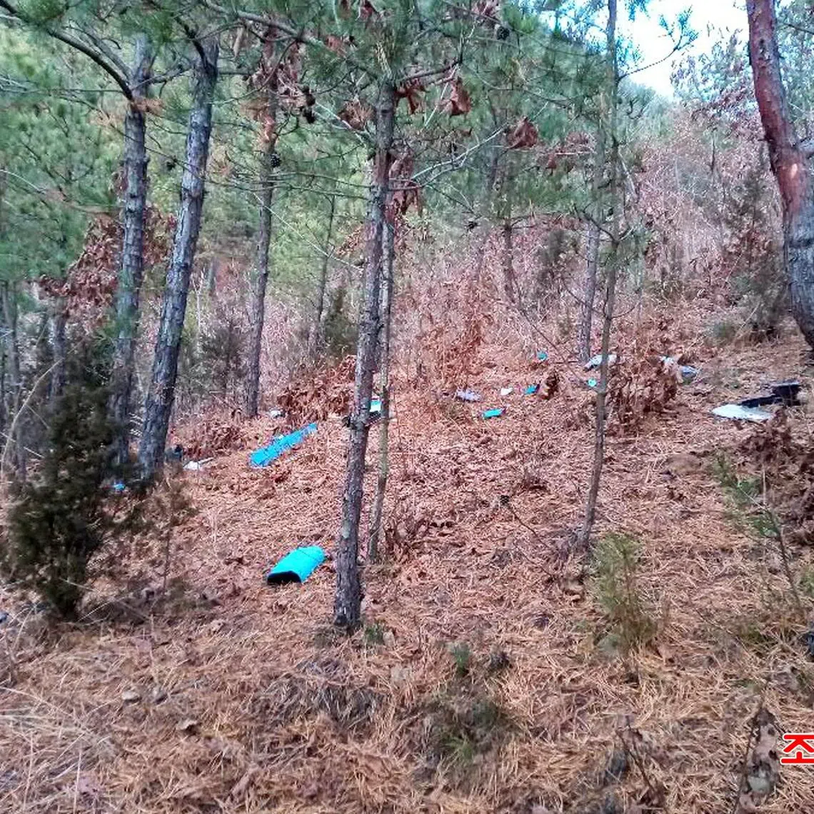 Fragments of a drone lying on the ground in the Muksan-ri area in Kaepung district, North Korea.