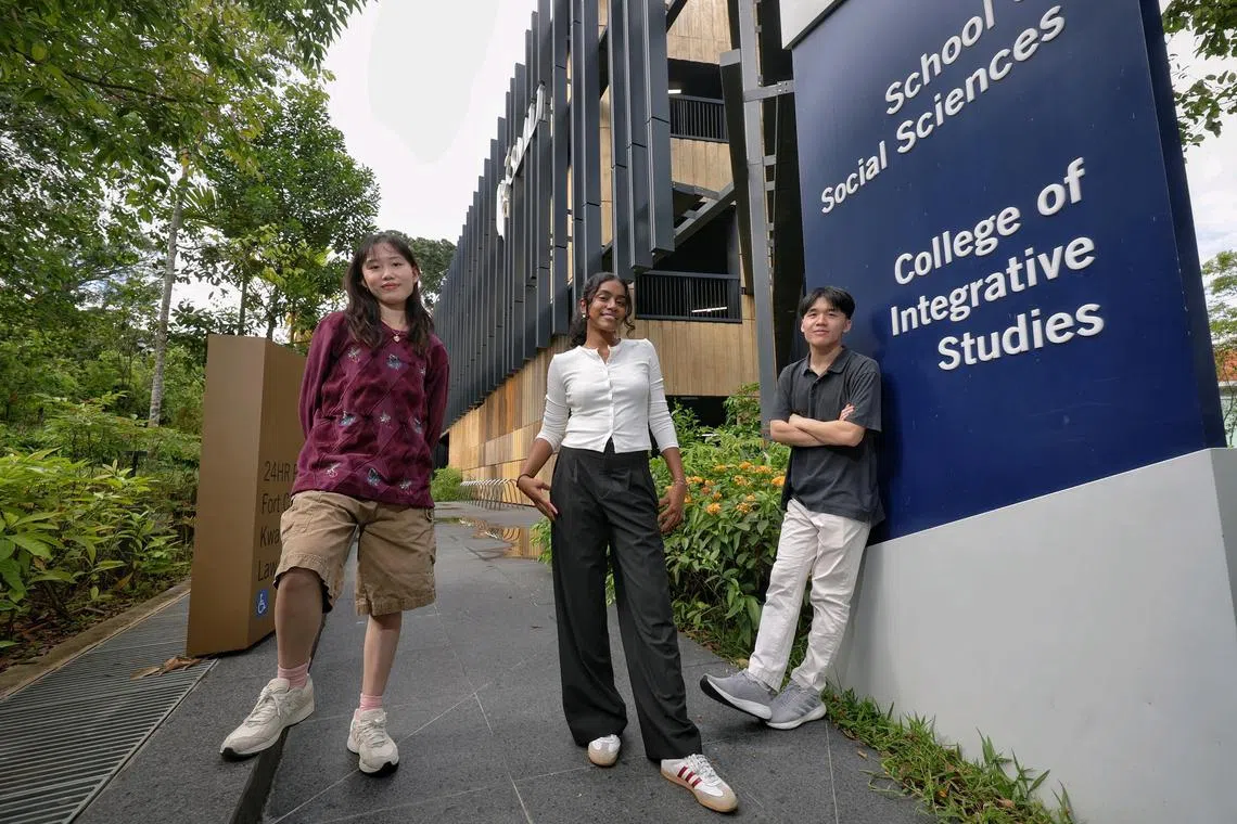 (From left) Singapore Management University's College of Integrative Studies undergraduates Raine Chiew, 20, major in Ethical Marketing through the Arts; M S Sudikshaa, 20, major in Environmental Diplomacy; and Alexander Tsai Yih-Rae, 22, major in Human-Computer Interfaces; in front of their school building on Oct 1, 2024.