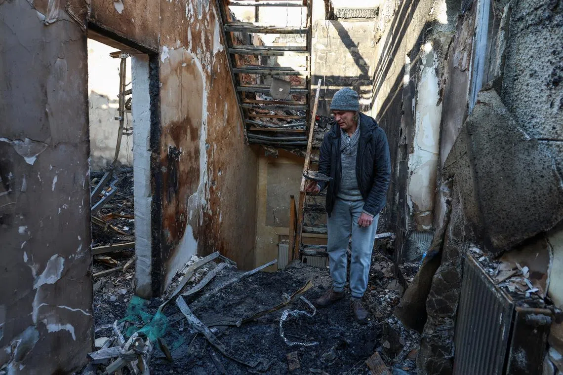 A resident stands inside of his house destroyed by a Russian drone strike, amid Russia's attack on Ukraine, in Odesa, Ukraine November 8, 2024. REUTERS/Nina Liashonok/File Photo