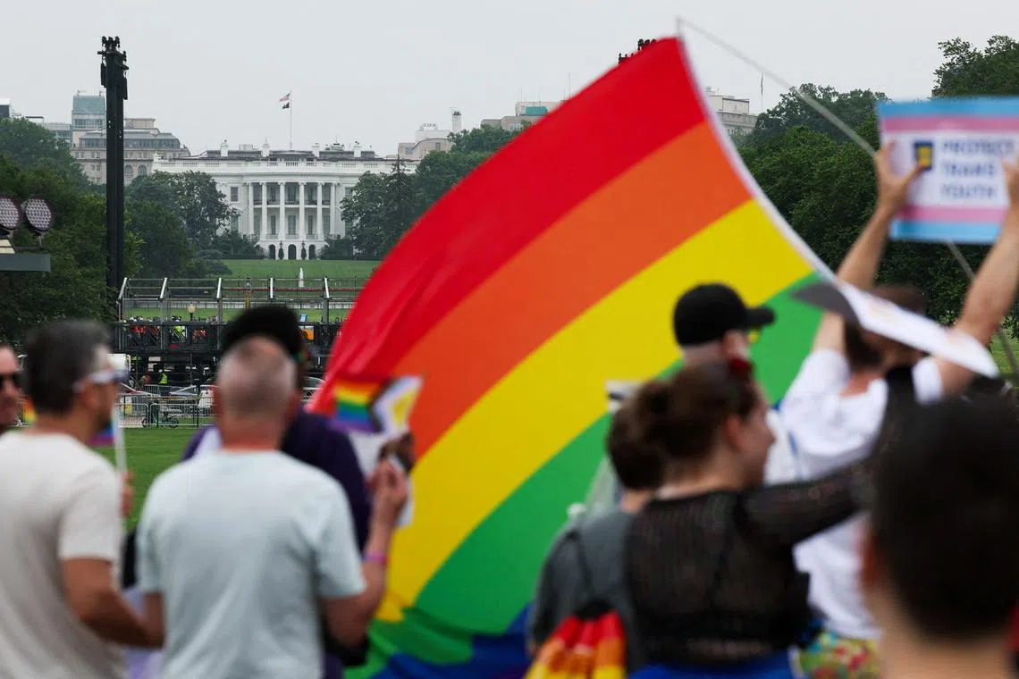 FILE PHOTO: People attend the \"International Rally + March on Washington for Freedom\" in support of LGBTQ+ rights as part of WorldPride, with the White House in the background, in Washington, D.C., U.S., June 8, 2025. REUTERS/Leah Millis/File Photo