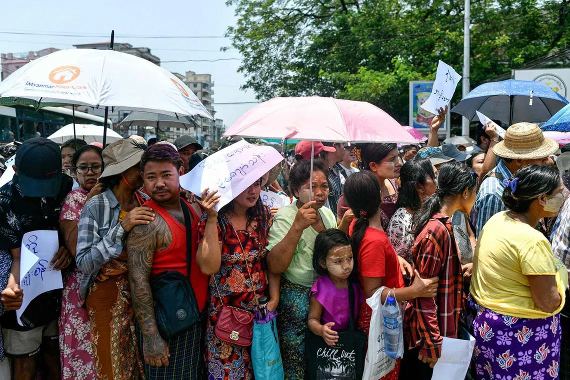 Relatives gathering around a bus carrying prisoners being released from Insein prison for the Buddhist New Year, in Yangon on April 17, 2024. Myanmar's junta announced a pardon for more than 3,300 prisoners under a regular amnesty to mark the country's traditional new year festival. 
