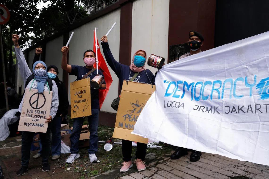 FILE PHOTO: People shout slogans during a protest against the military coup in Myanmar, outside Myanmar's embassy in Jakarta, Indonesia February 5, 2021. REUTERS/Willy Kurniawan/File Photo