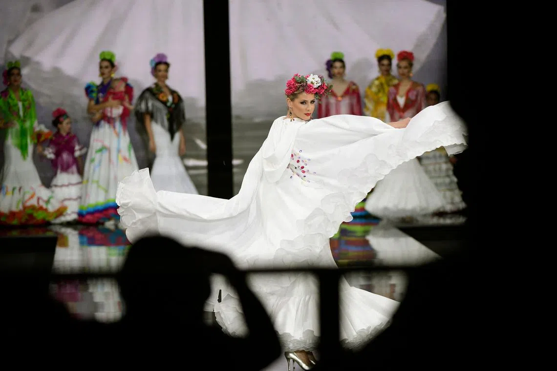 A model presents a creation by Hermanas Serrano during the Simof 2023 (International Flamenco Fashion Show) in Sevilla on Jan 29, 2023.