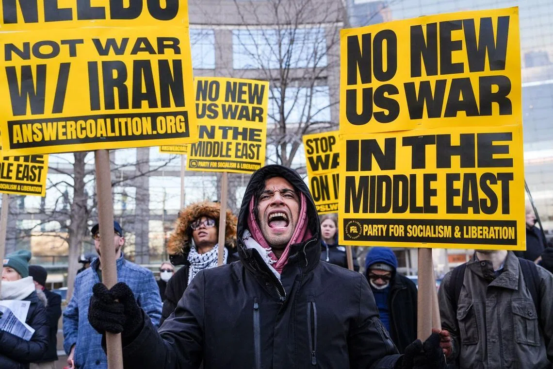 A person holds placards and chants slogans as they rally during a protest against US military action in Iran in New York City, on March 2, 2026. The United States hit hundreds of targets across Iran, and Israel expanded its bombing to Lebanon on March 2 as President Donald Trump vowed to avenge the first US deaths in the war he launched to topple Tehran's ruling clerics. Iranian forces fired missiles and drones across the Middle East, killing people in Israel and the United Arab Emirates, in retaliation for the conflict that began February 28 with the death of Iran's supreme leader, Ayatollah Ali Khamenei. (Photo by Ryan MURPHY / AFP)
